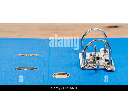 Empty open blued folder for papers with a metal clip, lying on a wooden table Stock Photo