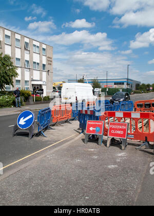 Road works with safety barriers blocking pedestrian footpath Stock Photo