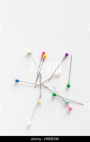 Macro image of many sewing pins for clothes making on white back Stock  Photo