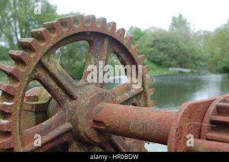 Mill machinery overlooking reservoir Stock Photo