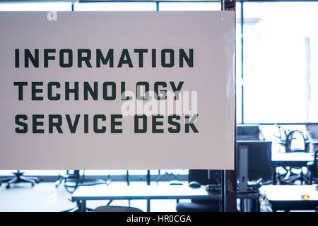 Sign reading "Information Technology Service Desk" at a university IT help desk or room. Stock Photo