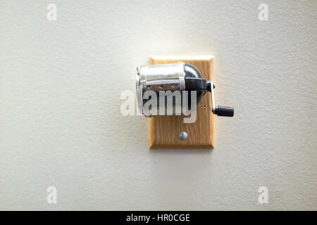 Pencil sharpener mounted on a wall. Stock Photo