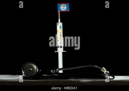 Stethoscope and syringe filled with drugs injecting the Belize flag on a black background Stock Photo