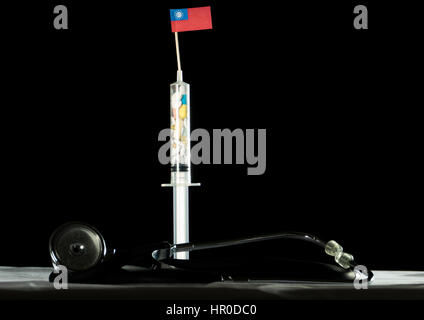 Stethoscope and syringe filled with drugs injecting the Myanmar flag on a black background Stock Photo