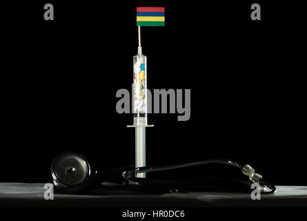 Stethoscope and syringe filled with drugs injecting the Mauritius flag on a black background Stock Photo