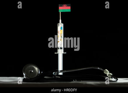 Stethoscope and syringe filled with drugs injecting the Malawi flag on a black background Stock Photo
