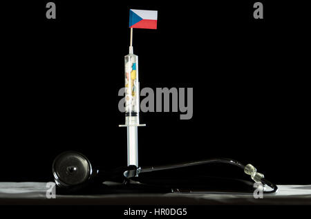 Stethoscope and syringe filled with drugs injecting the Czech flag on a black background Stock Photo