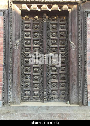 Ancient stone and woods carving with Hindus symbol for prying in Bhaktapur, Place of devotees. Also known as Bhadgaon or Khwopa, an ancient Newar. Stock Photo