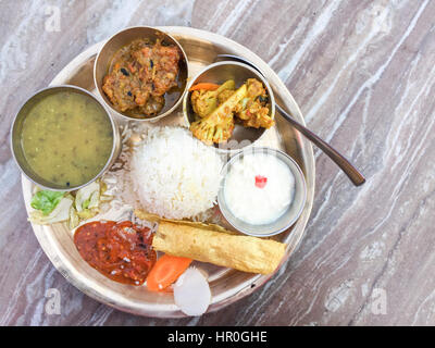 Selective focus of Traditional Nepalese food - Fish Thali or Thakali (dal bhat) in a restaurant. Stock Photo