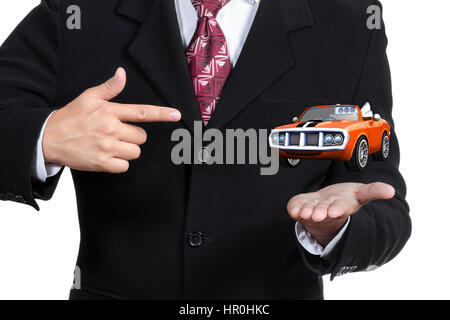 Businessman points finger of one hand on the three-dimensional cabriolet located above the other open hand close-up isolated on white background Stock Photo
