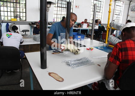 Johannesburg, South Africa. 06th Feb, 2017. An employee with the project Consol Solar Jar bends a wire in a factory in Johannesburg, South Africa, 06 February 2017. Preserving jars are the plain foundation of a South African success story. A screw-on lid with solar cells go on them. Street artists bend the wire used to hang them. When it's done it is a simple solar lamp. Photo: Jennifer Heck/dpa/Alamy Live News Stock Photo