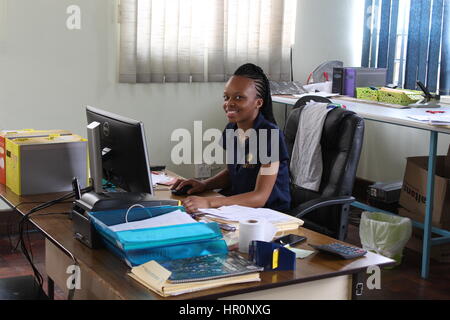 Johannesburg, South Africa. 06th Feb, 2017. Accountant Florinah (24) sits at her desk in the office next to the factory in Johannesburg, South Africa, 06 February 2017. Preserving jars are the plain foundation of a South African success story. A screw-on lid with solar cells go on them. Street artists bend the wire used to hang them. When it's done it is a simple solar lamp. Photo: Jennifer Heck/dpa/Alamy Live News Stock Photo