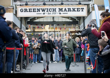 London, UK. 25th Feb, 2017. People take part in an annual Greenwich Market pancake warmup race, named the Big Flippin' Warm Up, ahead of the grand final to take place on Shrove Tuesday at Greenwich Market, in London, Britain, on Feb. 25, 2017. Credit: Tim Ireland/Xinhua/Alamy Live News Stock Photo