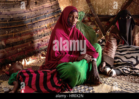 Abshiro Said sitting with her daughter Fatima in a tent in Uusgure, Somalia, 22 February 2017. The 19-year-old had a miscarriage a few weeks ago. She was pregnant in the sixth month. Her family, nomadic shepherds, have lost nearly 600 goats due to the ongoing drought. 'We eat and cook what the neighbours give us,' says the young woman. Some 6.2 million people in Somalia are dependent on humanitarian aid as a result of a severe drought. Should there be no rapid relief, the country in the Horn of Africa is under threaten of famine. In 2011 more than 250,000 people died in Somalia as a result of Stock Photo