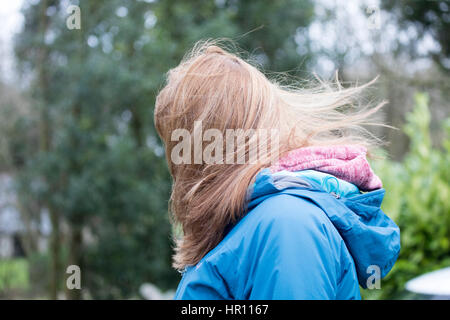 Windswept hair of a woman being blown in the wind Stock Photo