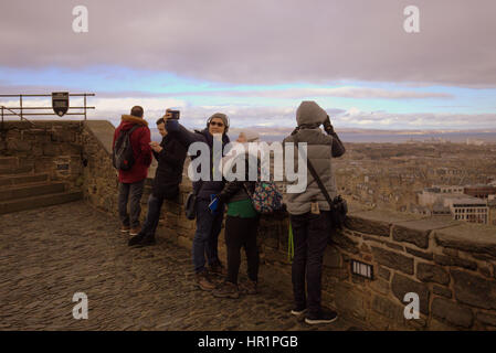 Edinburgh castle tourists on the ramparts inside the castle taking ...