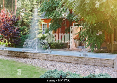Natural decorative yard with fountain and arch Stock Photo