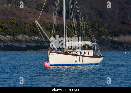 Classic wooden yacht on swinging mooring by Rudders Boatyard in the upper reaches of the Cleddau, Pembrokeshire, Wales Stock Photo