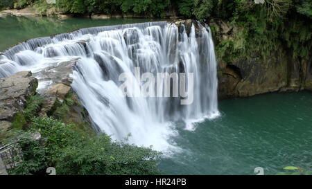 Shifen Waterfall, a scenic waterfall located in Pingxi District, New Taipei City, Taiwan, on the upper reaches of the Keelung River. Stock Photo
