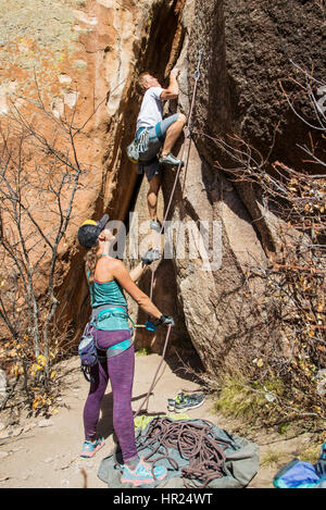 Young couple rock climbing; Penitente Canyon; Colorado; US Stock Photo