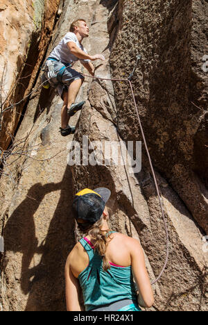 Young couple rock climbing; Penitente Canyon; Colorado; US Stock Photo