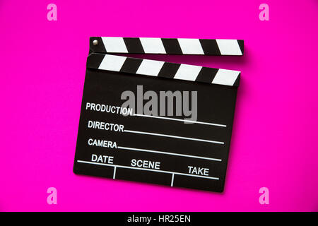 The vintage clapperboard on pink background. Top view. Stock Photo