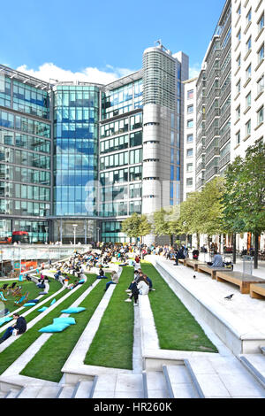 Sheldon Square UK office apartment & shop development in Paddington Central landscaped urban amphitheatre people on stone seats late summer London UK Stock Photo