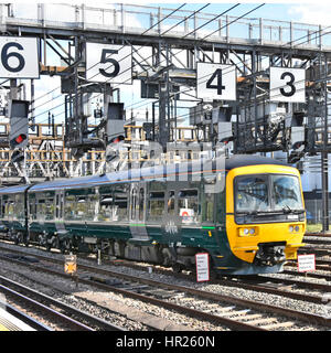 Train signalling UK railway tracks GWR train on rail tracks just outside London Paddington station passing below signal gantry oversized numbers Stock Photo