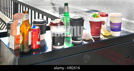 Rubbish left from office workers lunch break after snacking in street beer bottle paper cups coffee cup cans garbage trash littering City of London UK Stock Photo