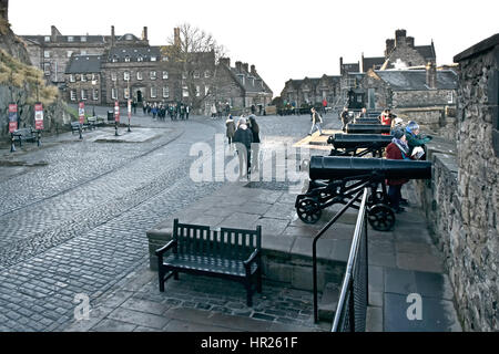 Cobbled street within Edinburgh Castle  visitor tourists admiring the views of the capital city from the famous Scottish Castle on a cold winter day Stock Photo