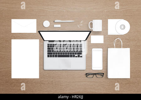 Laptop computer, mobile phone, stationery and office suplies on desk. Isolated white, blank items for mockup, design logo presentation. Stock Photo