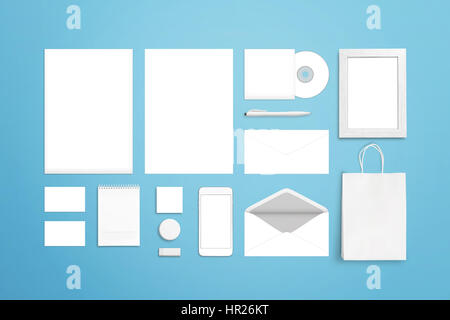 Branding corporate identity template. White blank stationery and office supplies. Top view of blue desk. Stock Photo