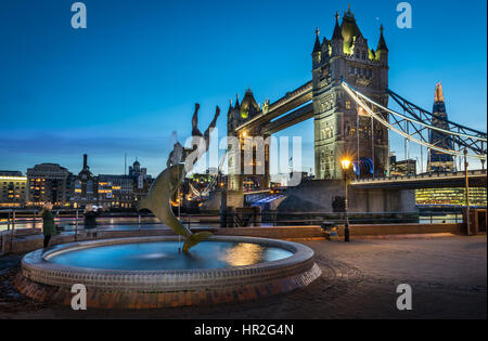 The lights come on at dusk on Tower Bridge on a calm but cold night in the capital city of London.