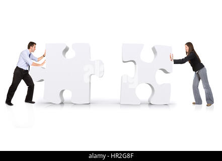 business partners building a puzzle over white Stock Photo