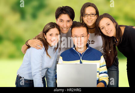 Casual group of students smiling outdoors in a park Stock Photo