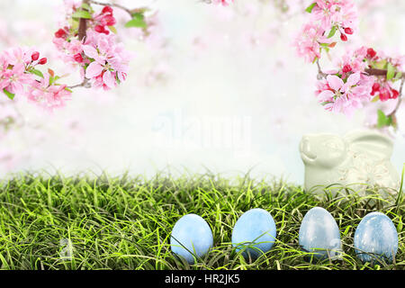 Easter eggs in grass with beautiful Crab Apple blossoms hanging overhead. Extreme shallow depth of field with selective focus on eggs. Stock Photo