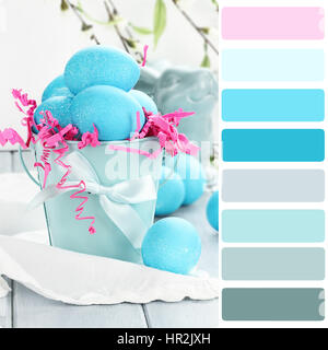 Blue Easter eggs in a blue tin bucket with color palette. Stock Photo