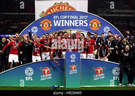 Manchester United players celebrate with the trophy after the EFL Cup Final at Wembley Stadium, London. Stock Photo