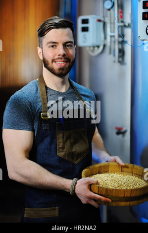 Brewer holds a grain malt beer Stock Photo