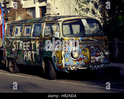 Old painted VW Kombi bus on a street of Ubud town. Bali, Indonesia Stock Photo