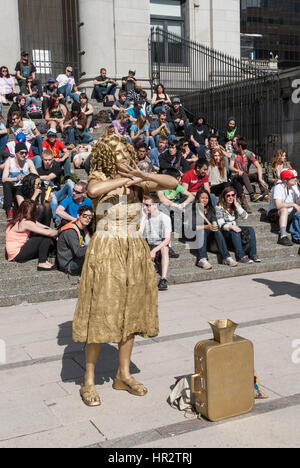 Woman painted gold busking in Vancouver. Stock Photo