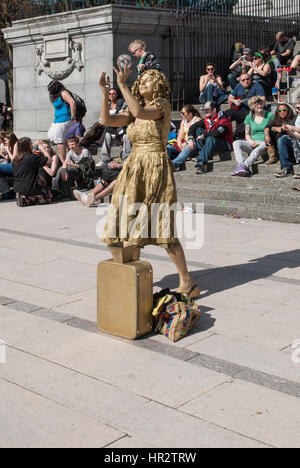 Woman painted gold busking in Vancouver. Stock Photo