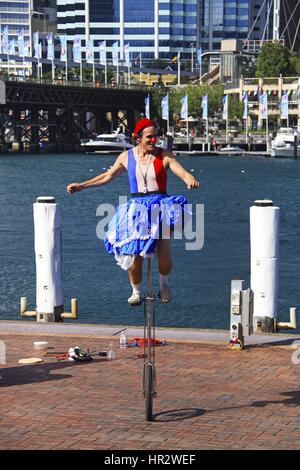 Street Performer balancing on Unicycle  in Harbor of Sydney, Australia Stock Photo