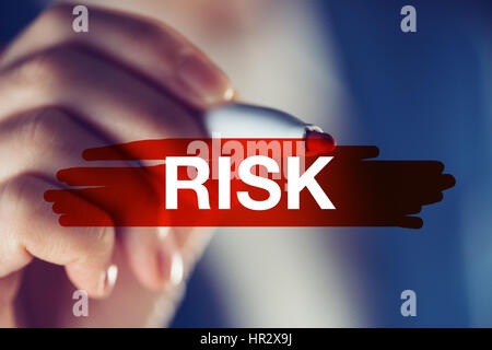 Risk in business concept, businesswoman marking the word with red highlighting marker pen Stock Photo