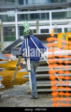 Surveyor equipment theodolite on tripod at building area, France Stock Photo