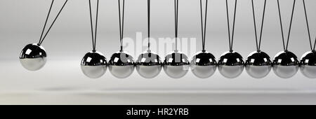 cause and effect concept banner, metal Newton's cradle on a white background Stock Photo