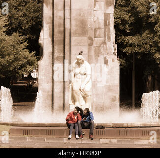 Couple near fountain in Garcia Sanabria park in Santa Cruz de Tenerife, Tenerife, Canary Islands, Spain Stock Photo