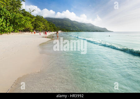 MAHE - AUGUST 08: Tourists and locals at Beau Vallon Beach in the west of Mahe, Seychelles on August 08, 2014 Stock Photo