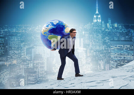 Businessman carrying Earth on his shoulders Stock Photo