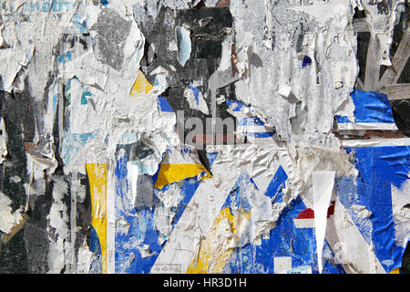 Wall with torn posters, may be used as background Stock Photo